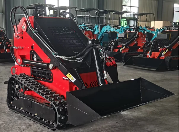 Stand-on mini track loader with rear platform and front bucket