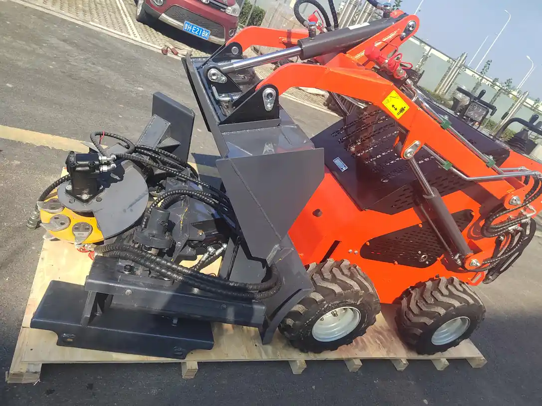 Compact loader with front bucket beside a loader fitted with pallet forks