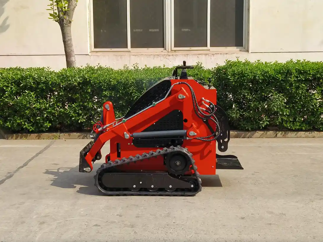 Red compact tracked skid steer viewed from the left side