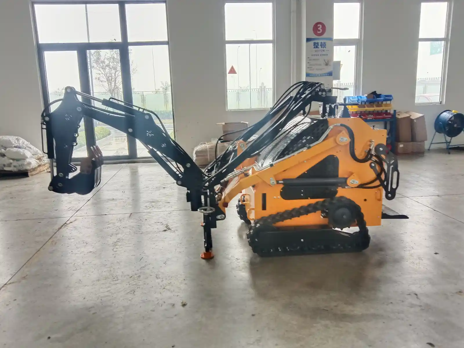 Technicians assembling compact tracked loaders in the skid steer workshop