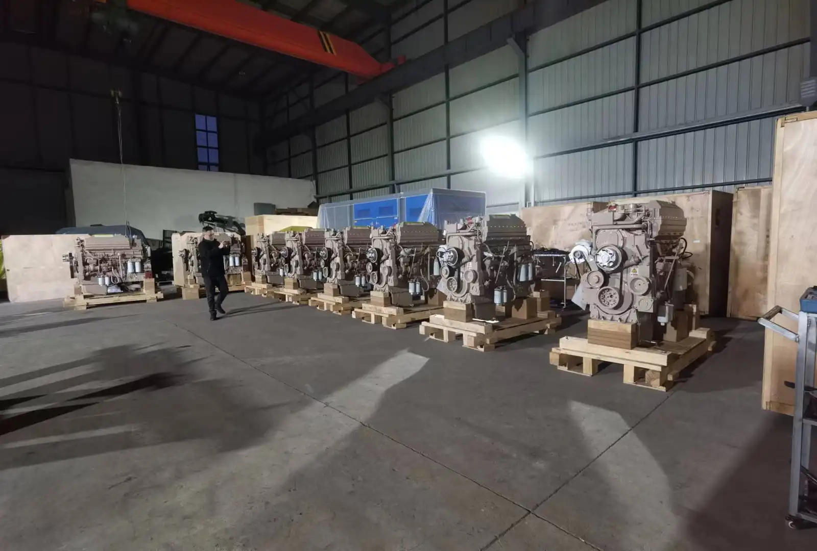 Industrial diesel engines arranged on pallets inside a workshop